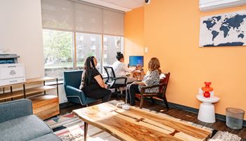 a group of people sitting at a table in a room with a large window  at Walnut Crossings, Monroeville, PA, 15146
